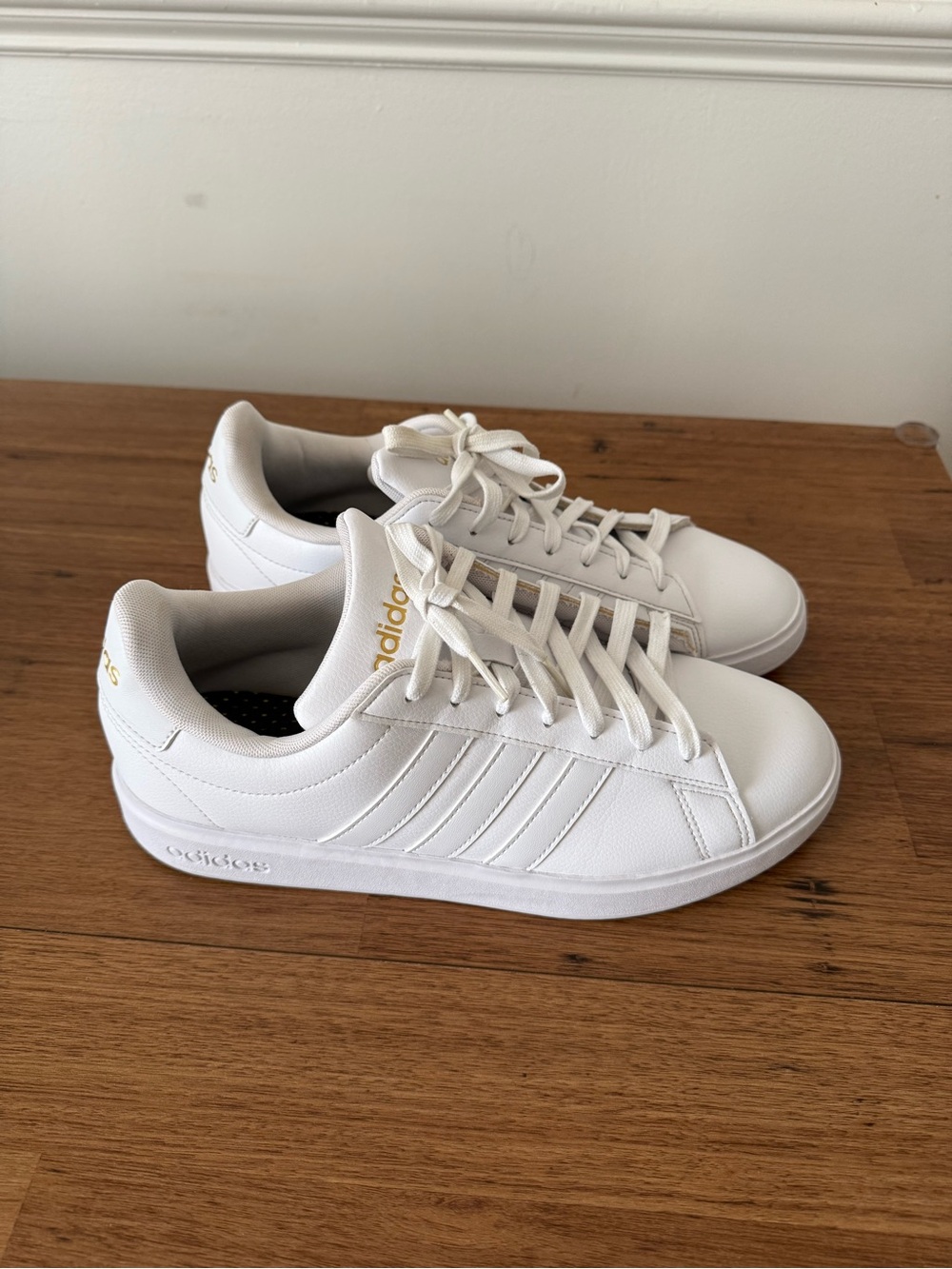 adidas White Leather Sneakers with Gold Branding
